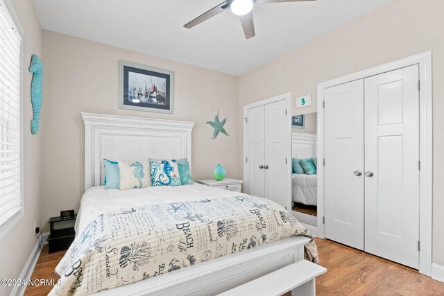 bedroom with ceiling fan, light hardwood / wood-style floors, and multiple windows