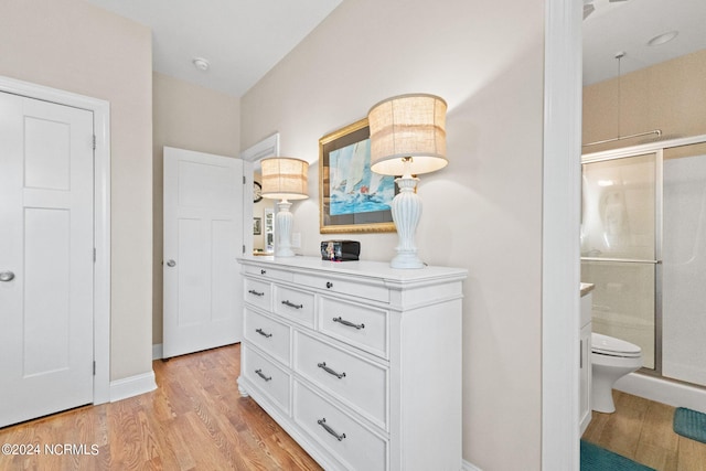 hall featuring light wood finished floors and baseboards