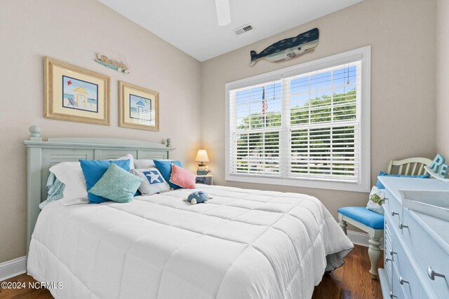 bedroom with dark hardwood / wood-style flooring and ceiling fan