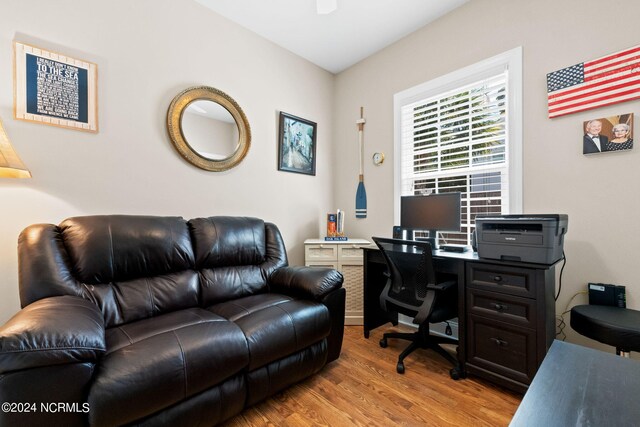 home office with light hardwood / wood-style floors