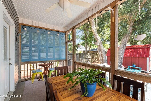 sunroom / solarium featuring ceiling fan and plenty of natural light