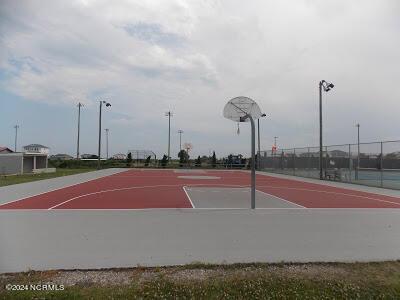 view of basketball court with community basketball court and fence