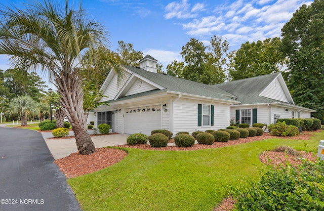 view of front of house featuring a front yard and a garage