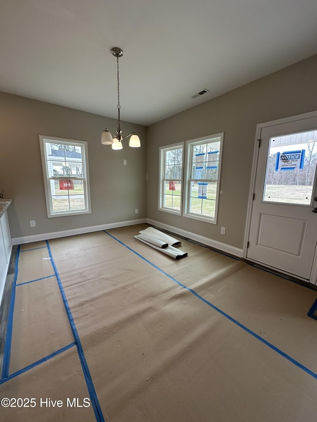 unfurnished dining area featuring an inviting chandelier