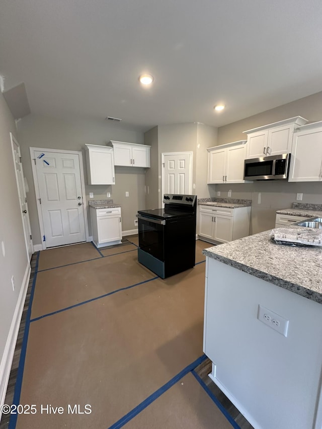 kitchen featuring electric range and white cabinets