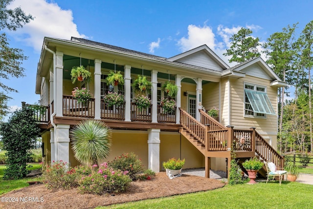 ranch-style home with stairs, a porch, and a front yard