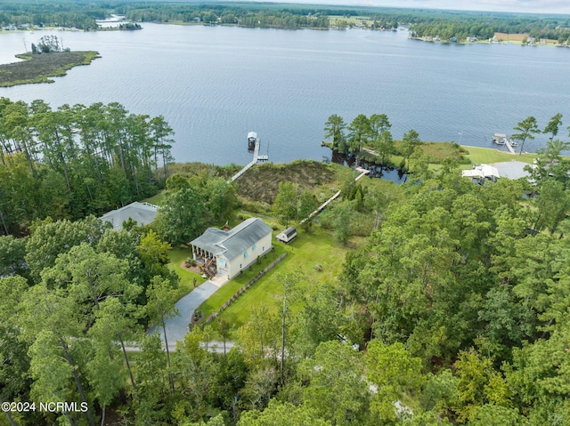 drone / aerial view featuring a water view and a forest view