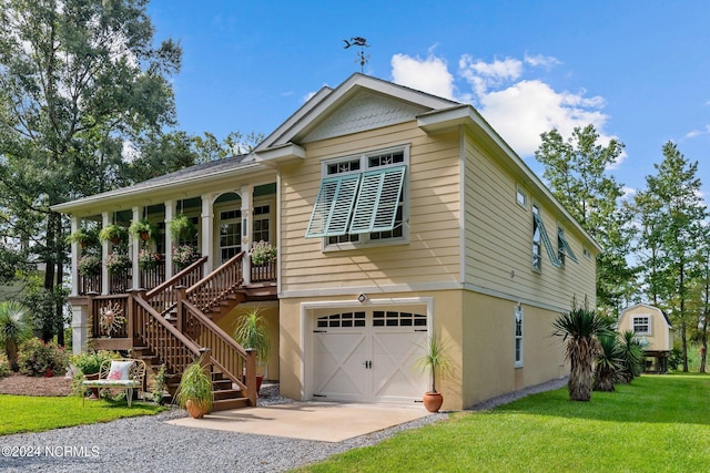 view of front of house featuring stairway, an attached garage, covered porch, a front lawn, and stucco siding