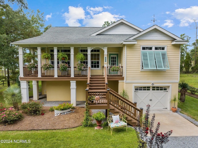 view of front facade featuring driveway, a shingled roof, stairway, an attached garage, and covered porch