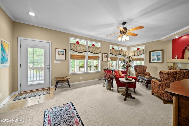 living room with crown molding, light carpet, and ceiling fan