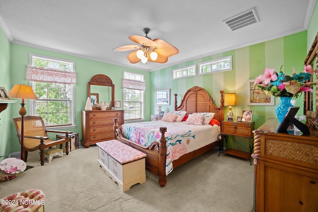 carpeted bedroom with multiple windows, ceiling fan, and ornamental molding