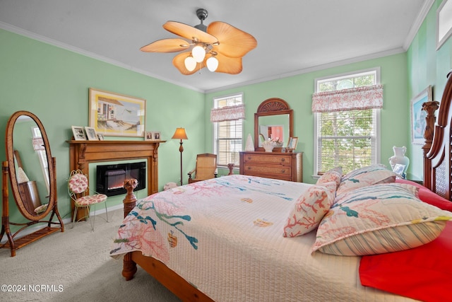 carpeted bedroom featuring a ceiling fan, a glass covered fireplace, and crown molding