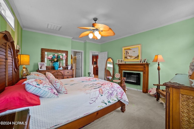 carpeted bedroom with multiple windows, ceiling fan, and crown molding