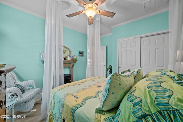 bedroom with crown molding, ceiling fan, a closet, and carpet flooring