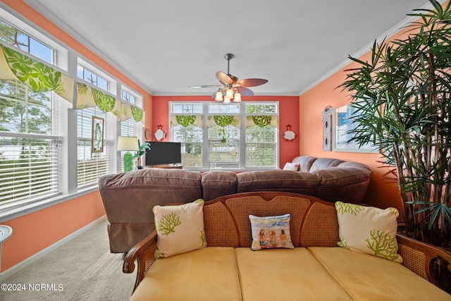 carpeted living room featuring crown molding and ceiling fan