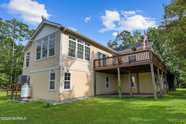 back of property featuring a lawn and a deck