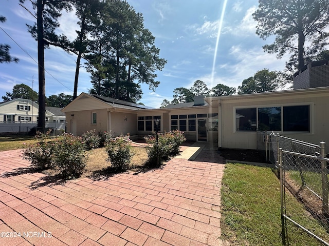 rear view of property with a yard