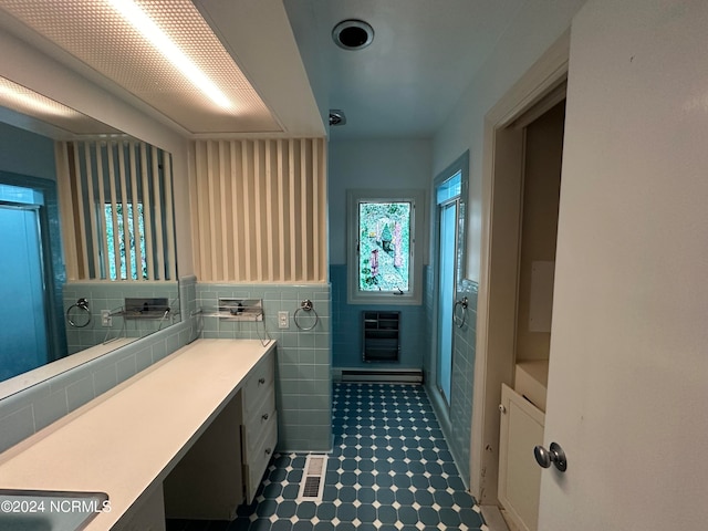 bathroom featuring backsplash, tile patterned flooring, and tile walls