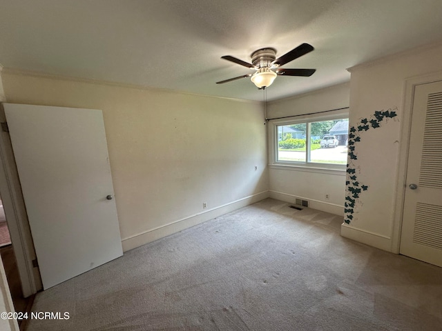 unfurnished bedroom featuring light colored carpet, a closet, and ceiling fan