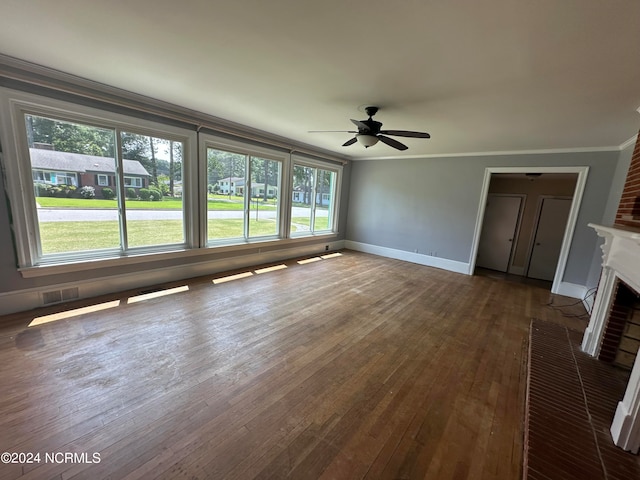 interior space featuring a fireplace, plenty of natural light, crown molding, and hardwood / wood-style flooring