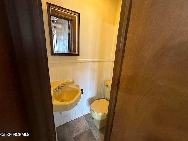 bathroom featuring sink, toilet, and tile patterned floors