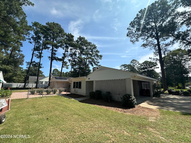 view of home's exterior featuring a carport and a yard