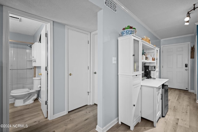 interior space featuring visible vents, white cabinetry, light countertops, light wood-type flooring, and open shelves