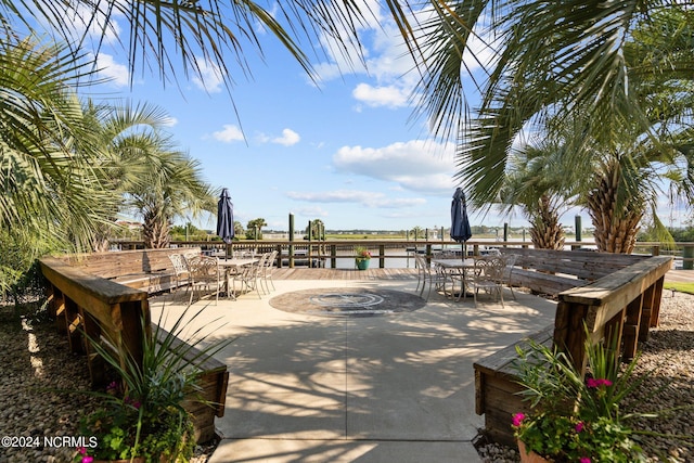 view of home's community with a water view and a patio