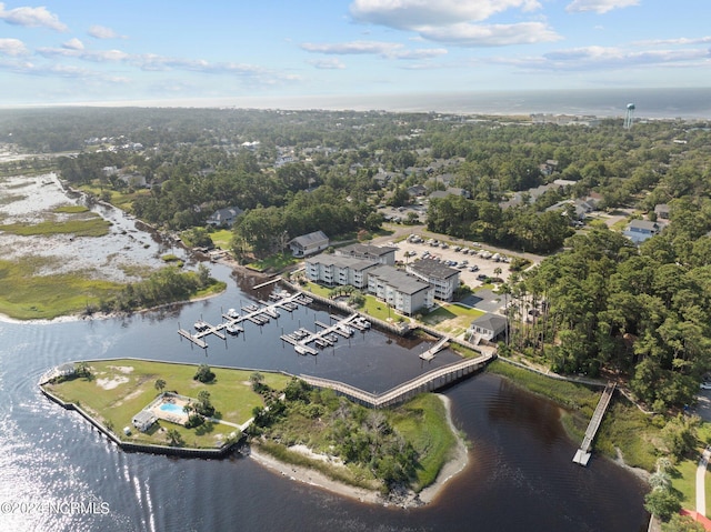 drone / aerial view featuring a water view and a wooded view