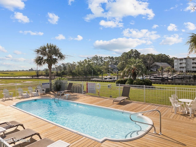 pool with fence and a deck