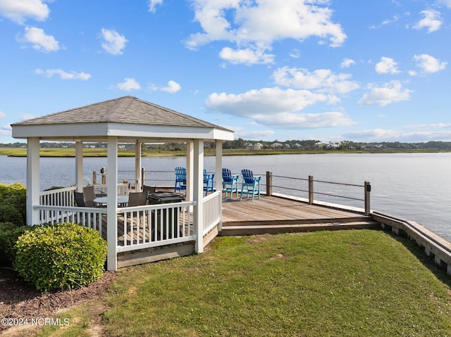 dock area featuring a gazebo, a yard, and a water view