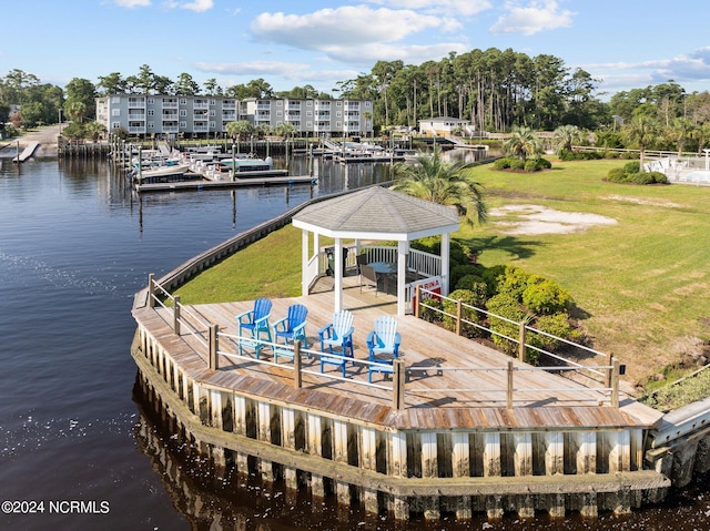 view of dock featuring a lawn, a gazebo, and a water view