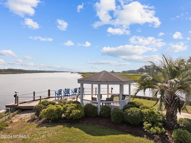 dock area with a water view, a yard, and a gazebo