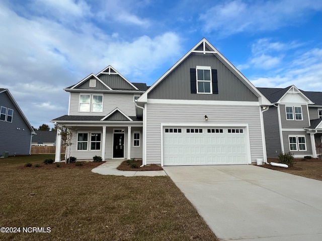 craftsman-style house featuring a front yard and a garage