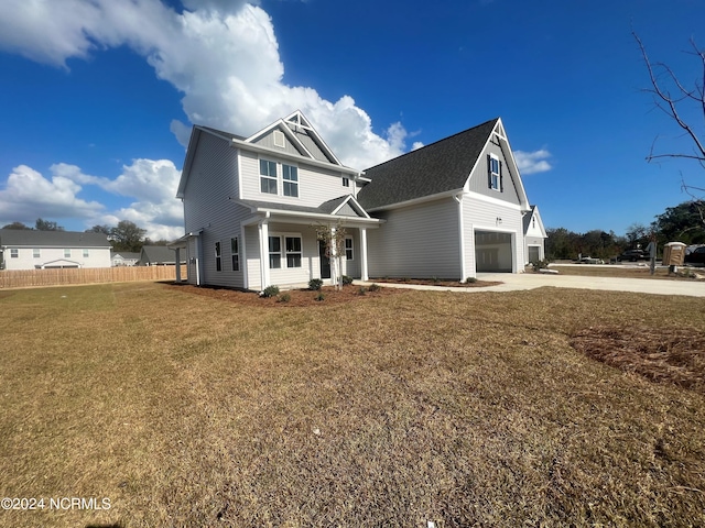 view of front of house with a front yard and a garage