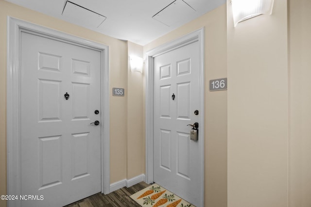 doorway to outside with baseboards and dark wood-style flooring