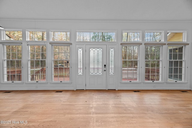 unfurnished sunroom with visible vents