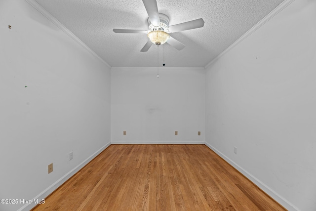 empty room with a textured ceiling, ornamental molding, and light wood-style flooring