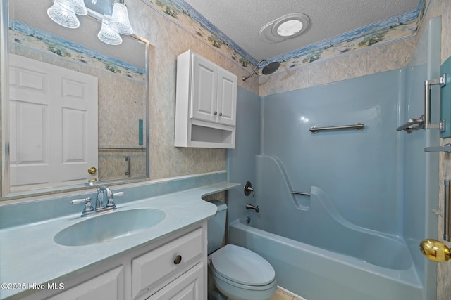 full bath with a textured ceiling, shower / washtub combination, vanity, and wallpapered walls