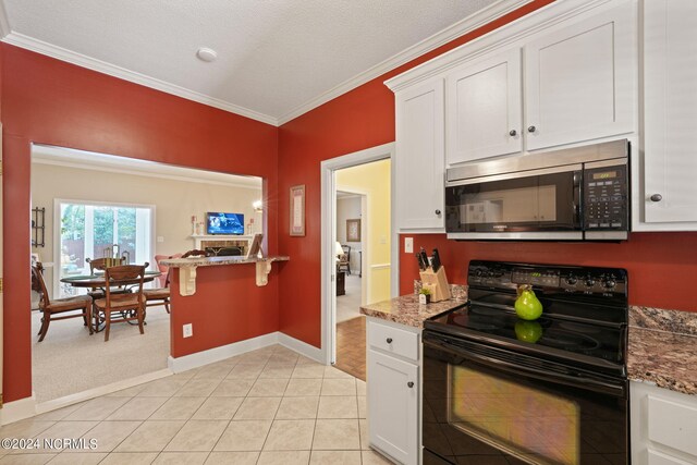 kitchen with crown molding, white cabinetry, black electric range, and a textured ceiling