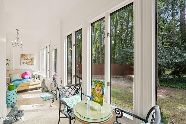 sunroom / solarium with a chandelier