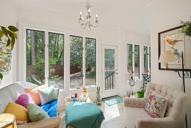 interior space with a notable chandelier, ornamental molding, tile patterned flooring, and a healthy amount of sunlight