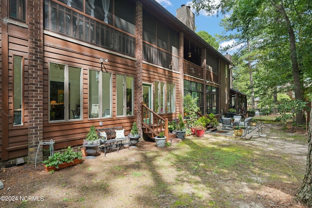 back of property with a patio area and a chimney