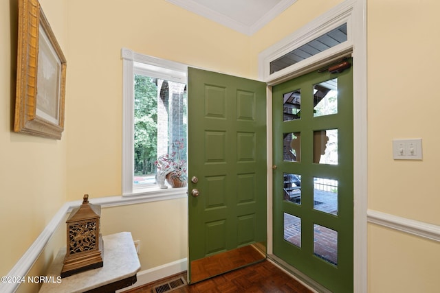 entryway featuring plenty of natural light, visible vents, crown molding, and baseboards