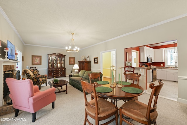 dining space featuring an inviting chandelier, crown molding, a brick fireplace, light colored carpet, and a textured ceiling