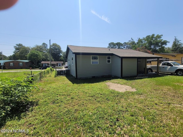 view of side of home with a yard