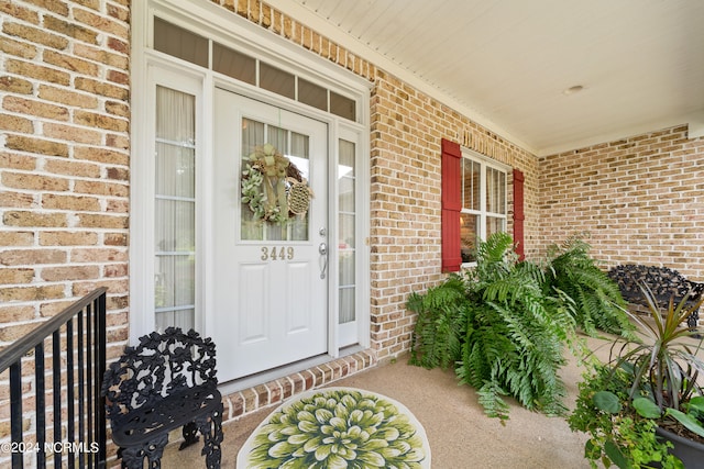 view of exterior entry with covered porch