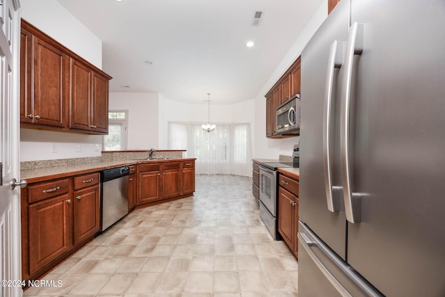 kitchen with sink, decorative light fixtures, appliances with stainless steel finishes, and a chandelier