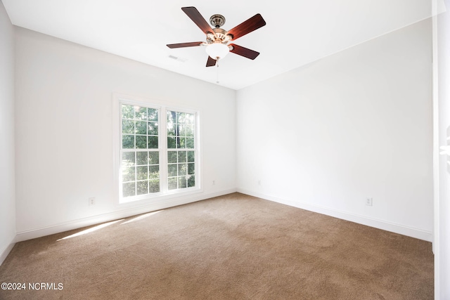 spare room with carpet and ceiling fan