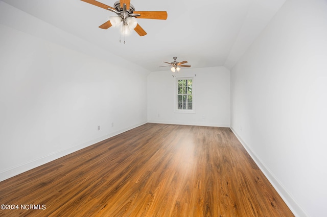 spare room featuring lofted ceiling, ceiling fan, and hardwood / wood-style flooring